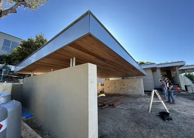 Timber-lined cantilever roof over an outdoor living area